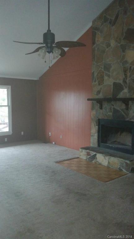 934 State Rd S-28-818 Elgin, SC 29045 - Photo 2 of 15 an empty room with a fireplace
