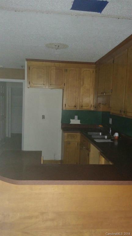 934 State Rd S-28-818 Elgin, SC 29045 - Photo 5 of 15 a kitchen with granite countertop a cabinets and a stove top oven