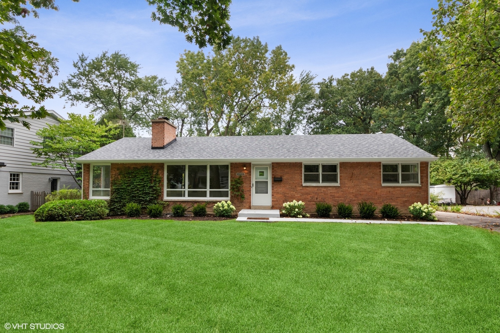 872 Northmoor Road Lake Forest, IL 60045 - Photo 1 of 23 a front view of a house with a garden and trees