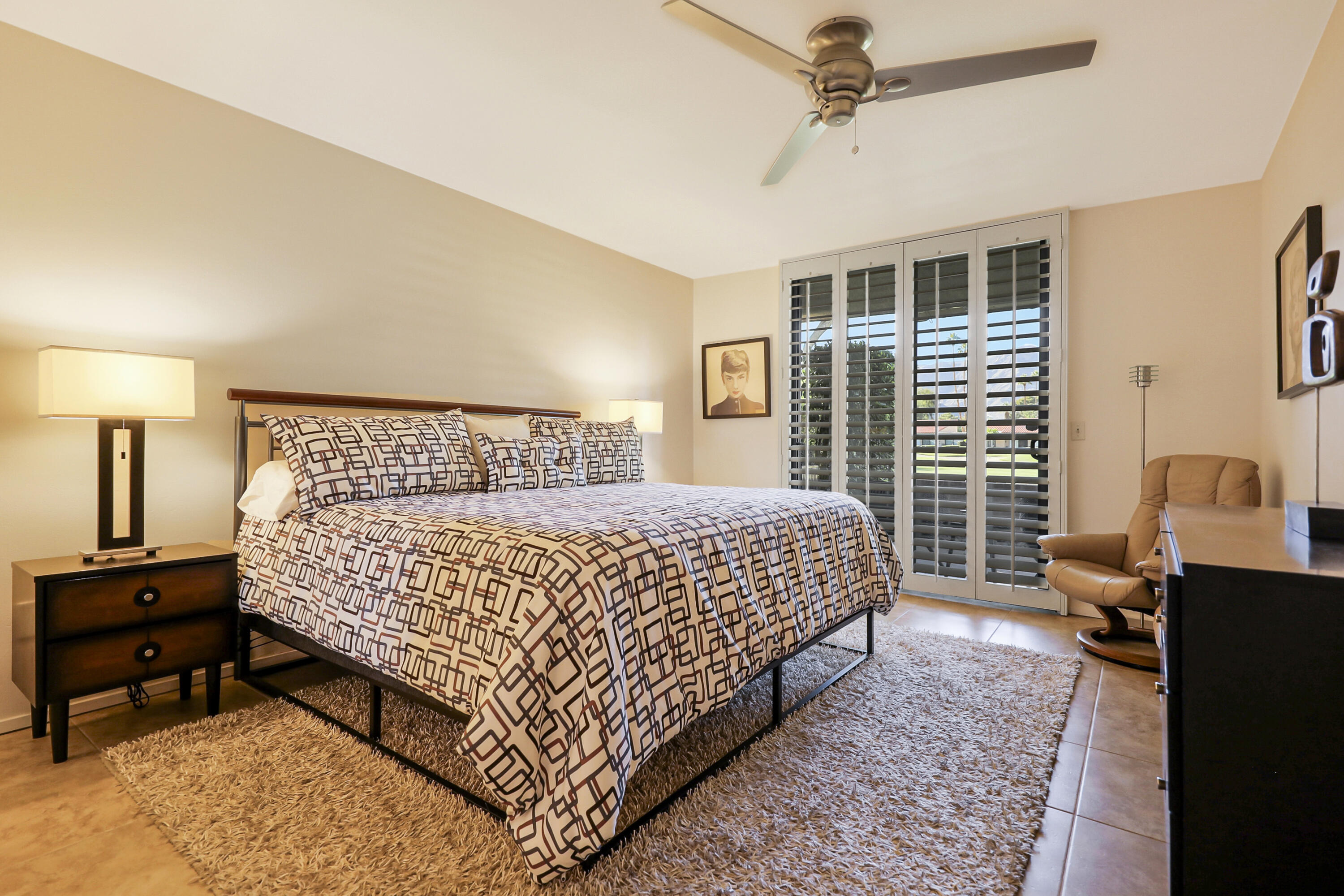 35 La Ronda Drive Rancho Mirage, CA 92270 - Photo 11 of 54 a bedroom with a bed and wooden floor