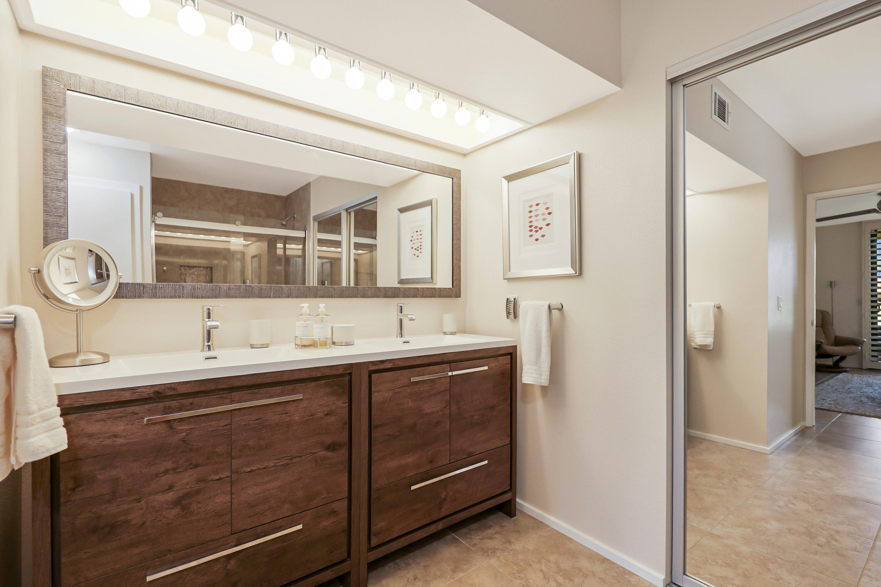 35 La Ronda Drive Rancho Mirage, CA 92270 - Photo 13 of 54 a bathroom with a sink and a mirror