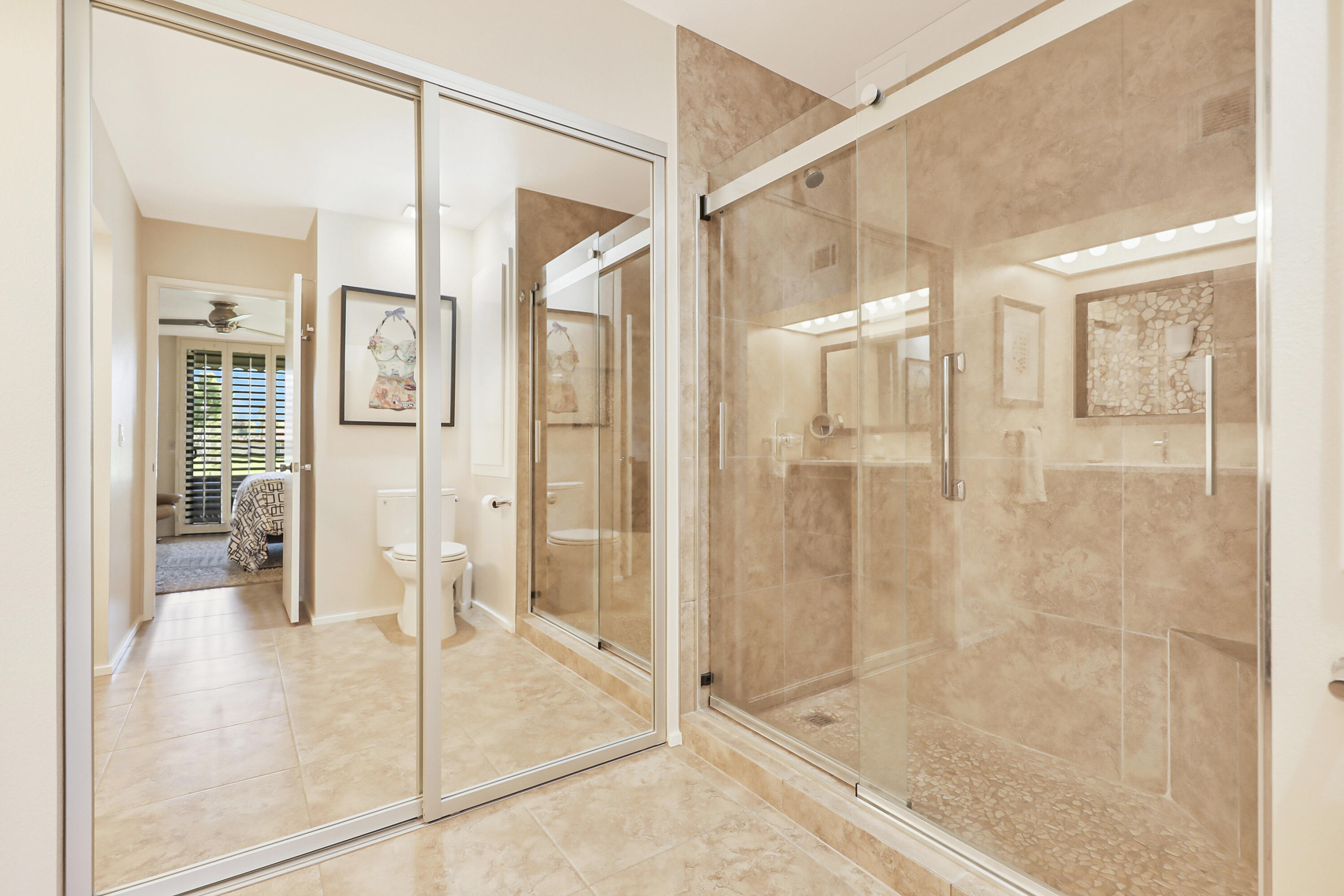 35 La Ronda Drive Rancho Mirage, CA 92270 - Photo 14 of 54 a bathroom with a glass shower door and a sink