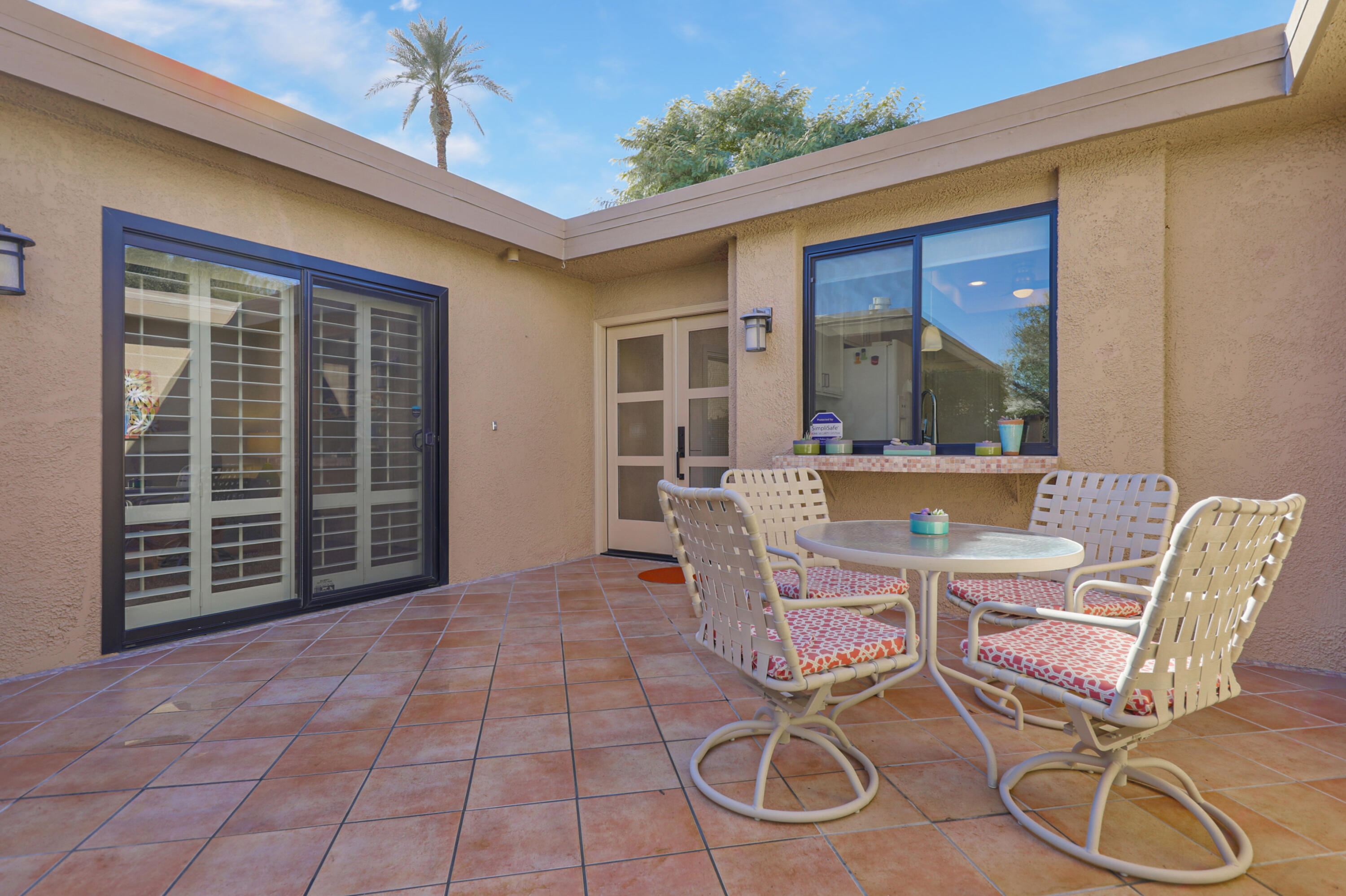 35 La Ronda Drive Rancho Mirage, CA 92270 - Photo 21 of 54 a view of a dining room with furniture and a window