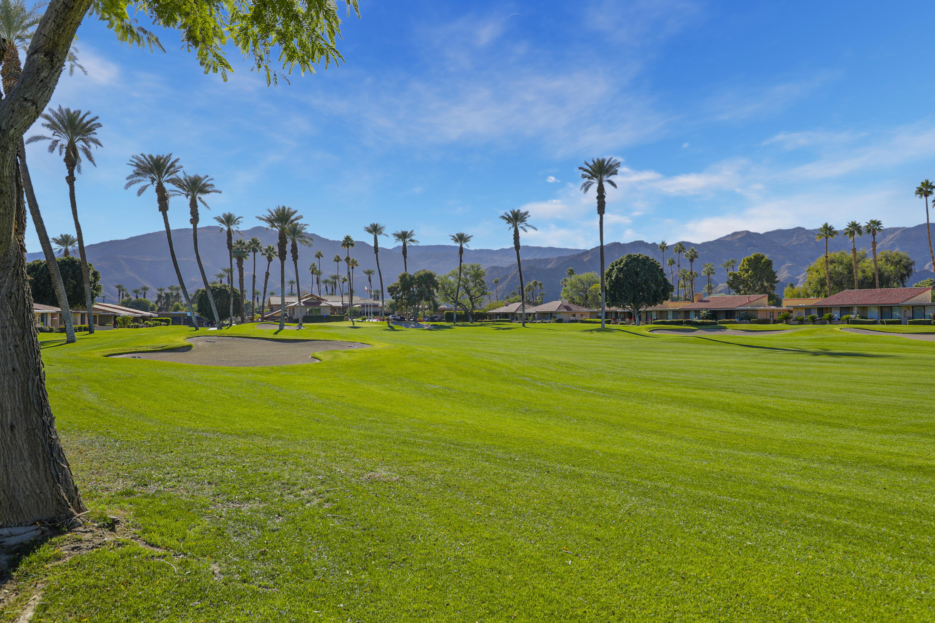 35 La Ronda Drive Rancho Mirage, CA 92270 - Photo 27 of 54 a view of a golf course with a lake view