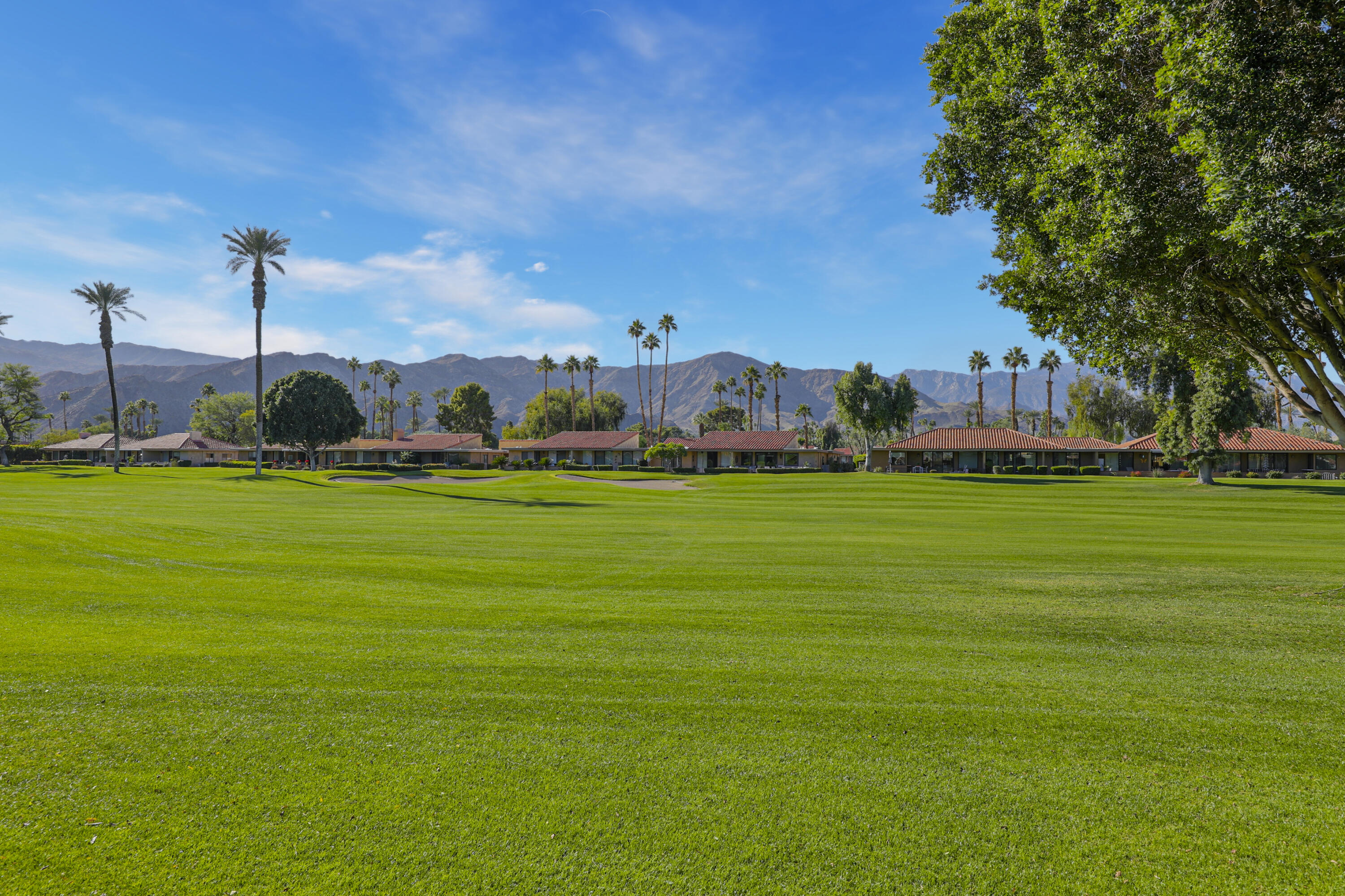 35 La Ronda Drive Rancho Mirage, CA 92270 - Photo 28 of 54 a view of a fountain in front of a house with a yard