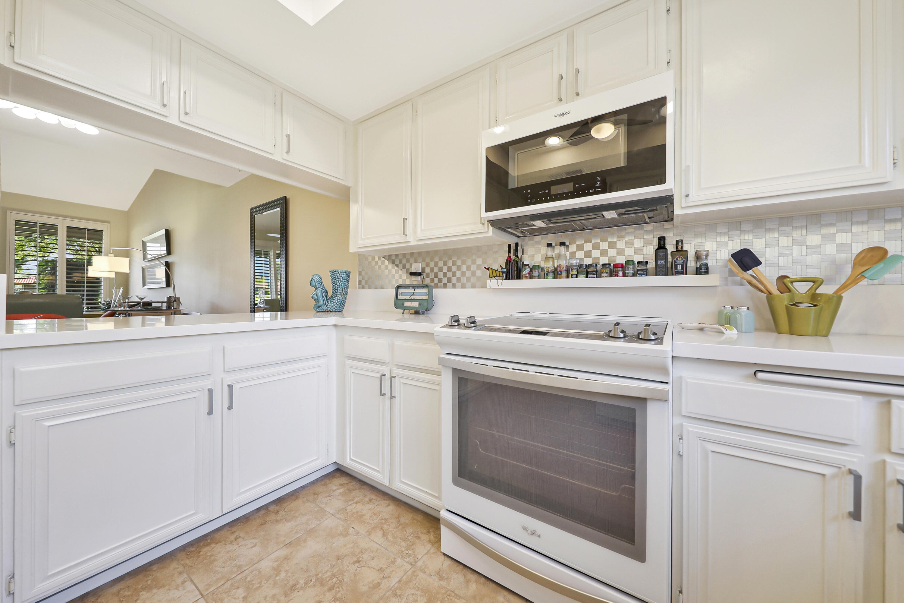 35 La Ronda Drive Rancho Mirage, CA 92270 - Photo 5 of 54 a kitchen with sink stove and microwave
