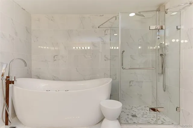 a bathroom with a shower a toilet and a shower