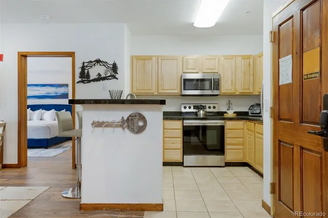a kitchen with a refrigerator and a stove