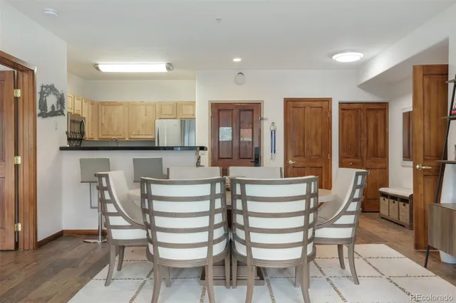 a view of kitchen with granite countertop cabinets and refrigerator