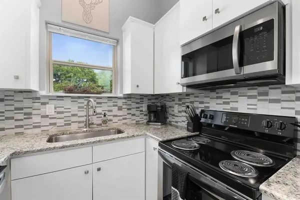 a kitchen with a stove microwave and sink