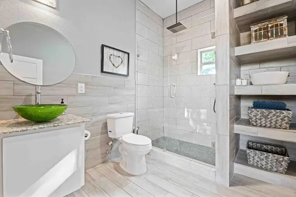 a bathroom with a sink toilet and shower