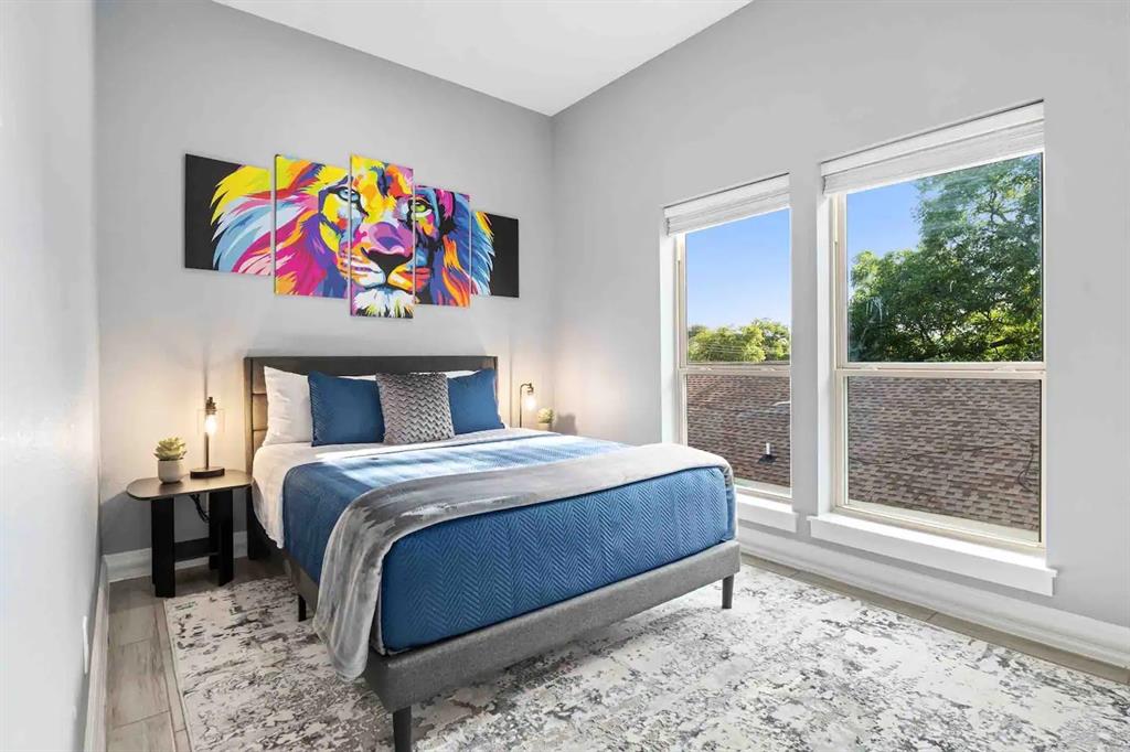 3807 Vilbig Road Dallas, TX 75212 - Photo 20 of 40 a bedroom with a bed a painting on the wall and a large window