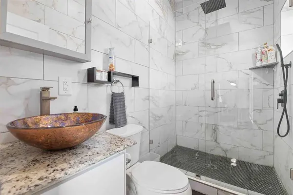 a bathroom with a granite countertop sink and a mirror