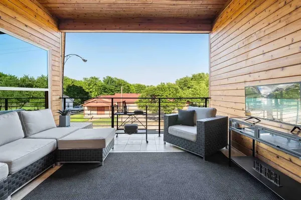 a balcony with furniture and a garden