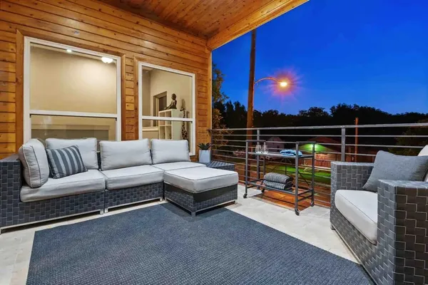 a roof deck with couches and city view