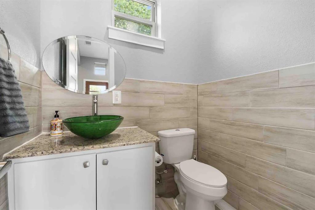 3807 Vilbig Road Dallas, TX 75212 - Photo 33 of 40 a bathroom with a granite countertop toilet sink and mirror