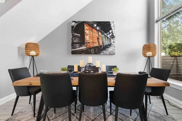 a view of a dining room with furniture and wooden floor