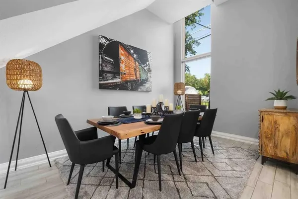 a view of a dining room with furniture and wooden floor