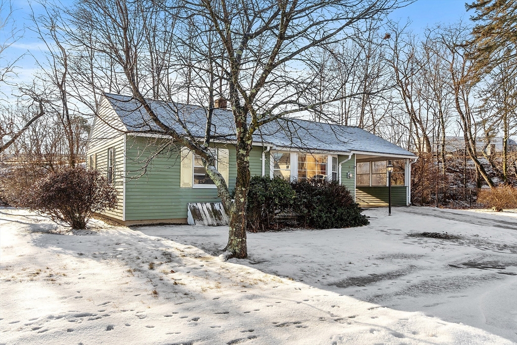 a view of a house with a yard covered in snow