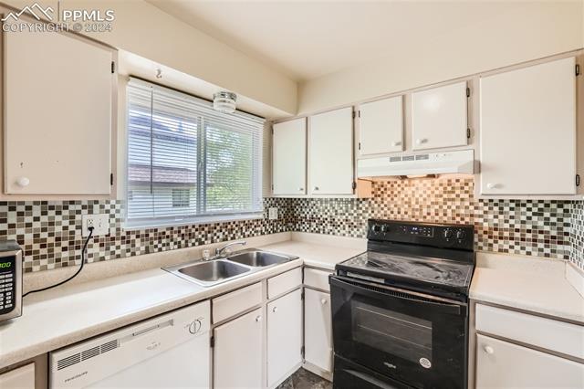 6450 Chippewa Road Colorado Springs, CO 80915 - Photo 5 of 10 Kitchen featuring electric range, sink, white cabinetry, and white dishwasher