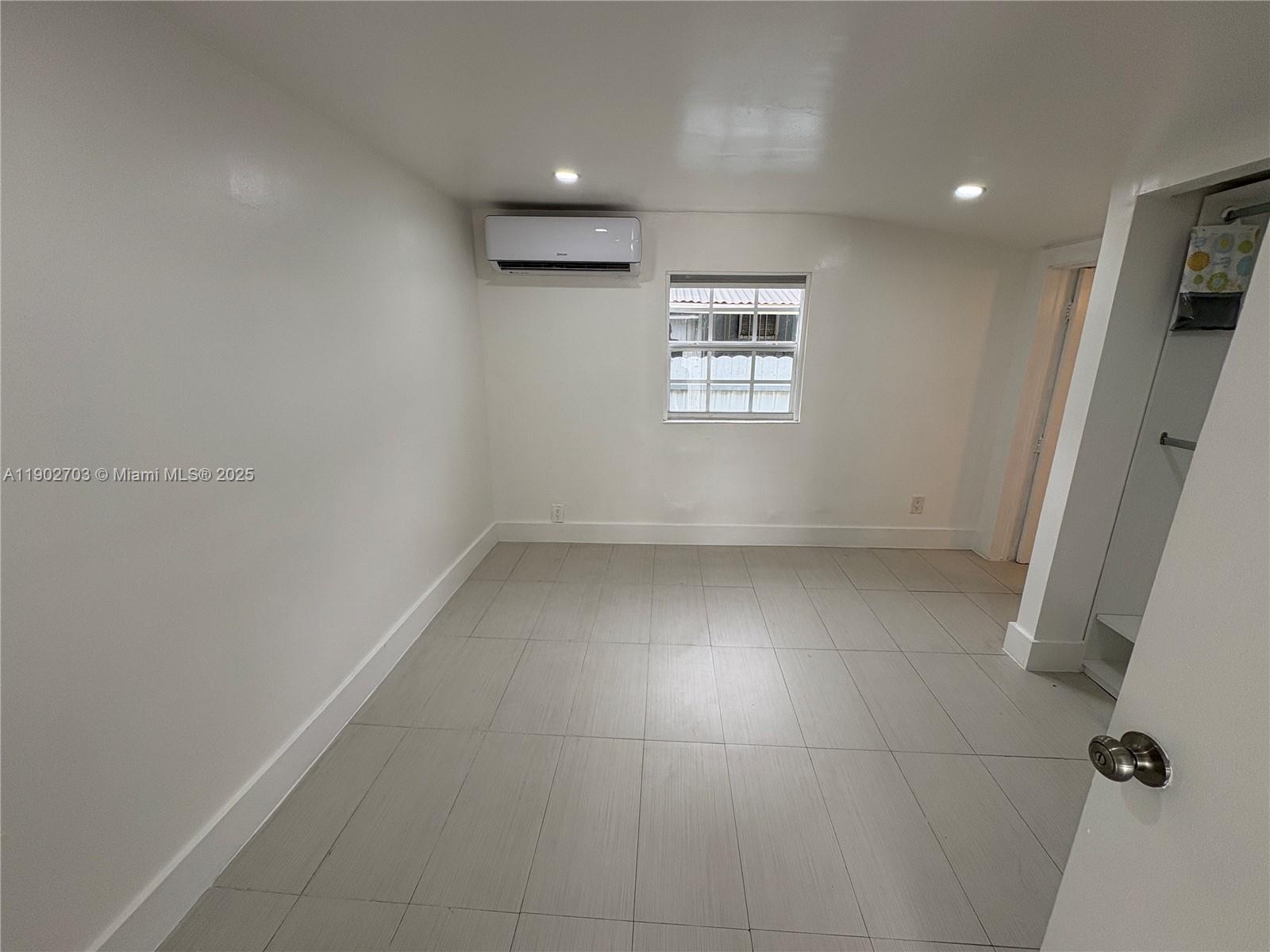 3157 Southwest 17th Street, Unit B Miami, FL 33145 - Photo 6 of 18 an empty room with windows