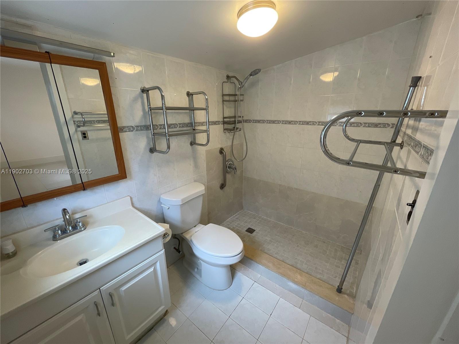 3157 Southwest 17th Street, Unit B Miami, FL 33145 - Photo 8 of 18 a bathroom with a sink a toilet and shower