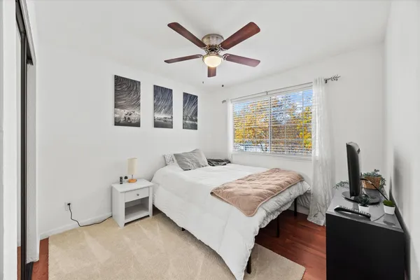 a bedroom with a bed and a window