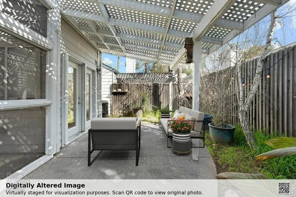 a backyard of a house with outdoor seating
