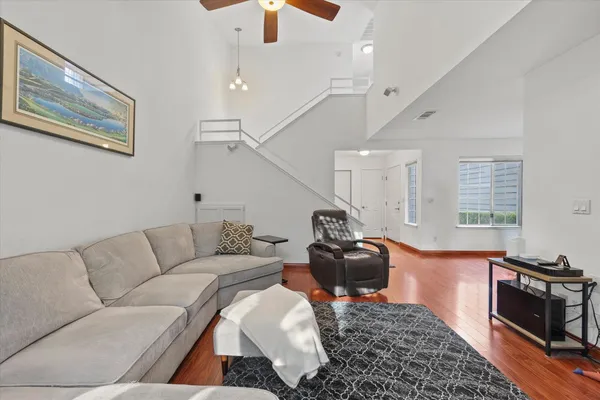 a living room with furniture and wooden floor
