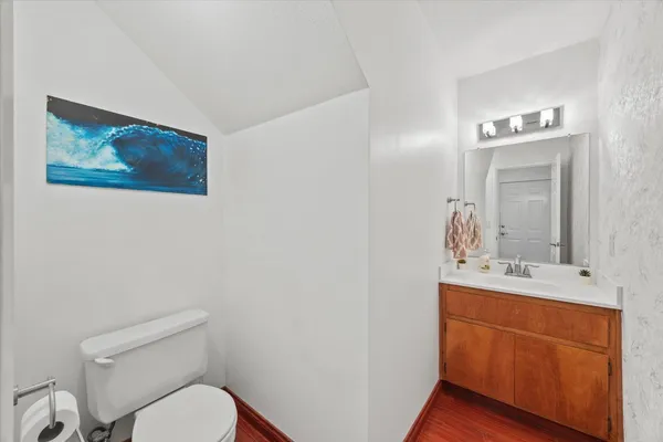 a bathroom with a toilet a sink and mirror