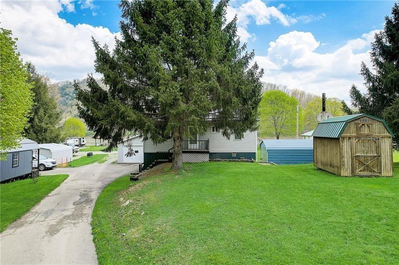 952 Seybertown Road East Brady, PA 16028 - Photo 30 of 46 a view of a garden with large trees