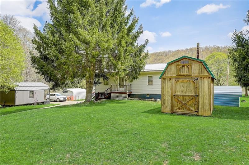 952 Seybertown Road East Brady, PA 16028 - Photo 33 of 46 a view of a tiny house with a big yard and large trees