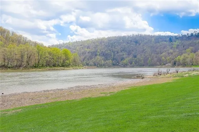a view of grassy field with mountain