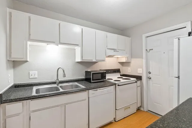 a kitchen with a refrigerator sink and stove