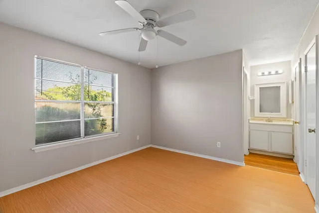 a small space with a fan and a window