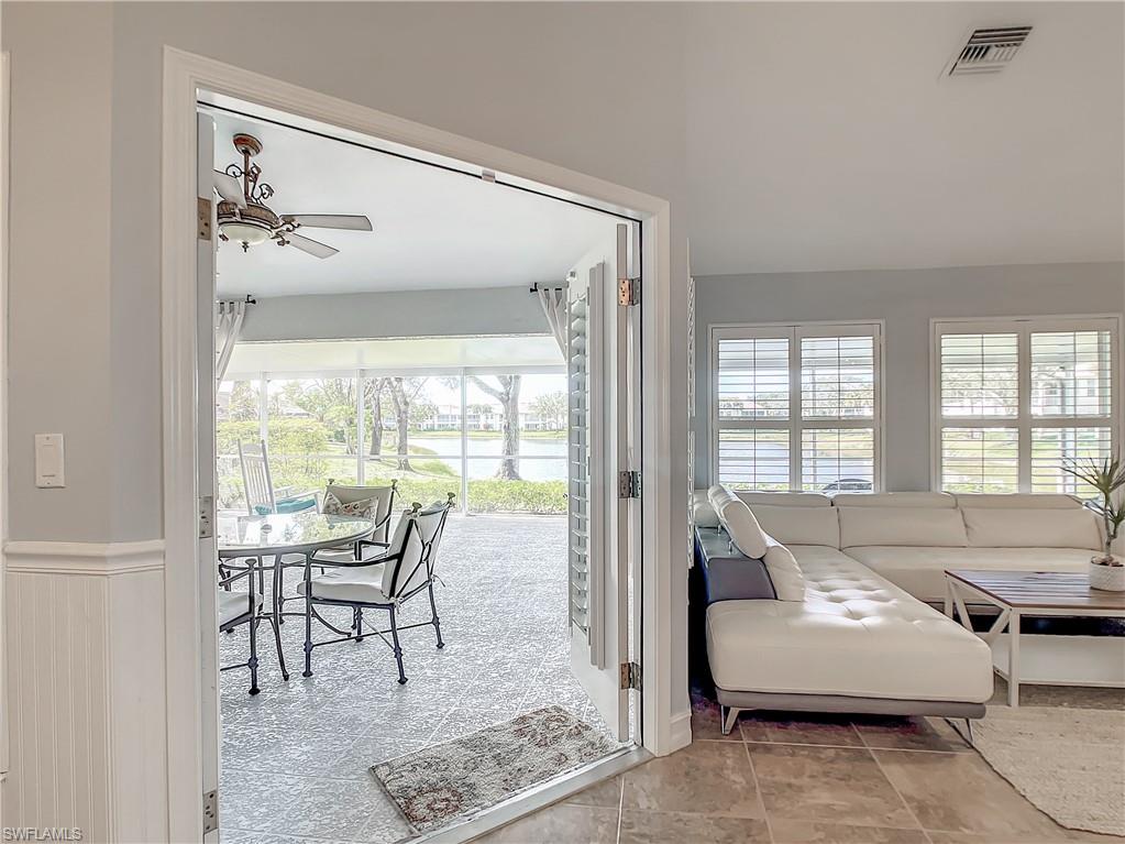 7858 Gardner Drive Naples, FL 34109 - Photo 11 of 35 a living room with furniture and a large window