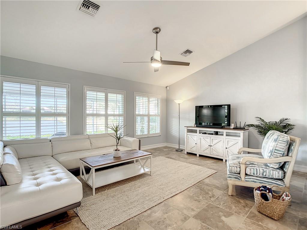 7858 Gardner Drive Naples, FL 34109 - Photo 12 of 35 a living room with furniture and a flat screen tv
