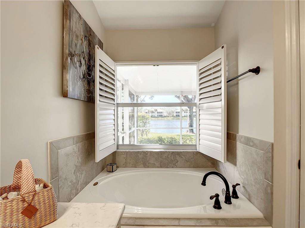 7858 Gardner Drive Naples, FL 34109 - Photo 28 of 35 a bathroom with a bathtub and window