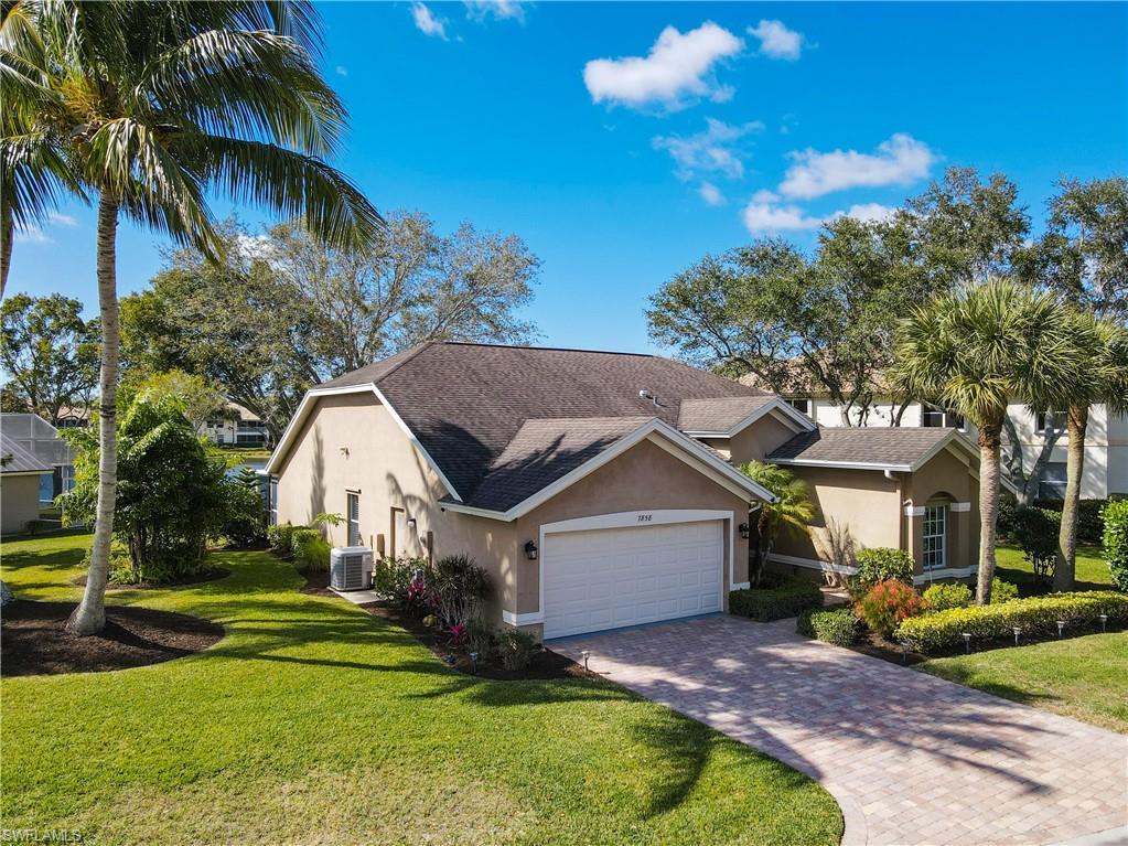 7858 Gardner Drive Naples, FL 34109 - Photo 3 of 35 a front view of a house with garden