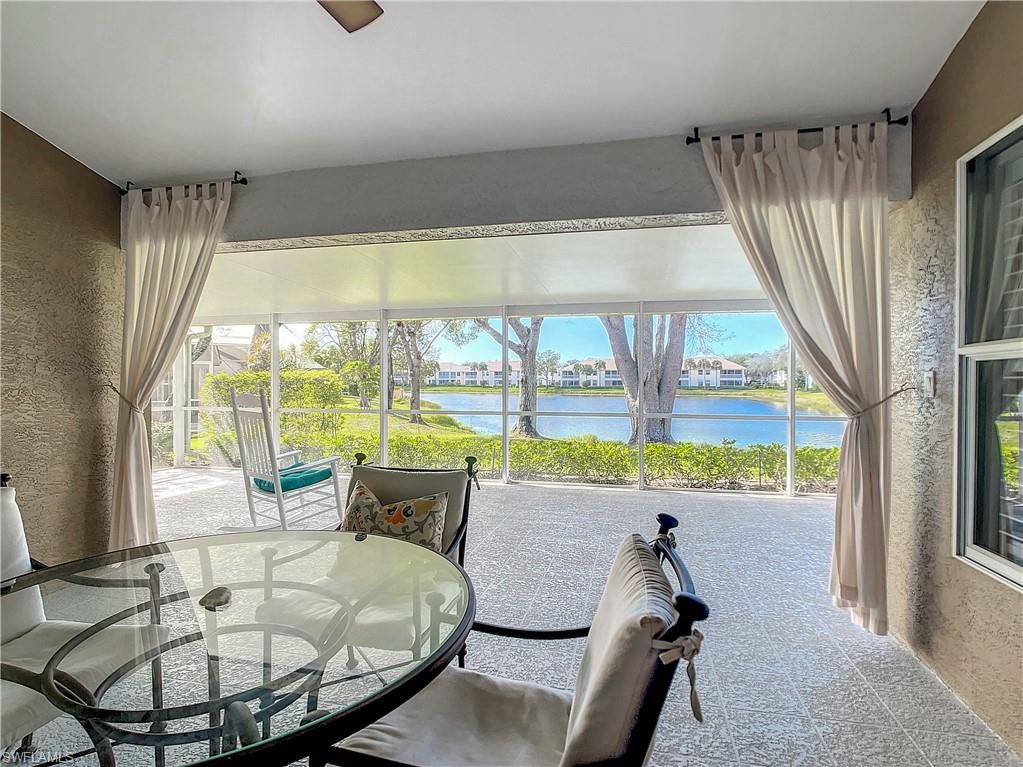 7858 Gardner Drive Naples, FL 34109 - Photo 33 of 35 a room with a large window and a table