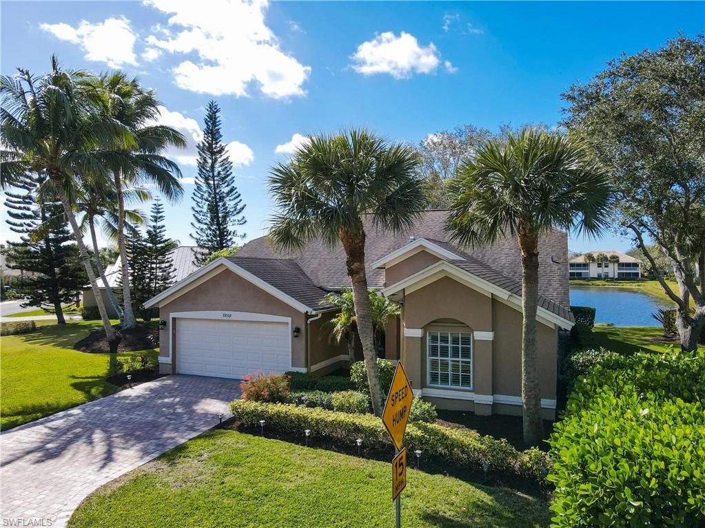 7858 Gardner Drive Naples, FL 34109 - Photo 4 of 35 a front view of house with yard and trees
