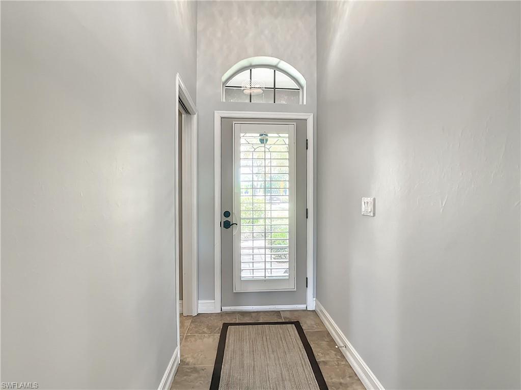 7858 Gardner Drive Naples, FL 34109 - Photo 9 of 35 a view of a livingroom with wooden floor and window