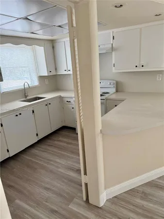a view of a kitchen with wooden floor