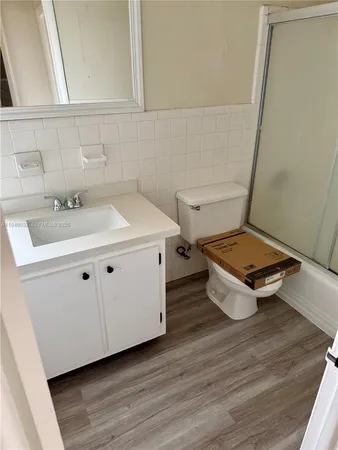 a room with a wooden floor and white walls