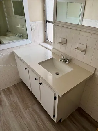 a bathroom with a sink and mirror