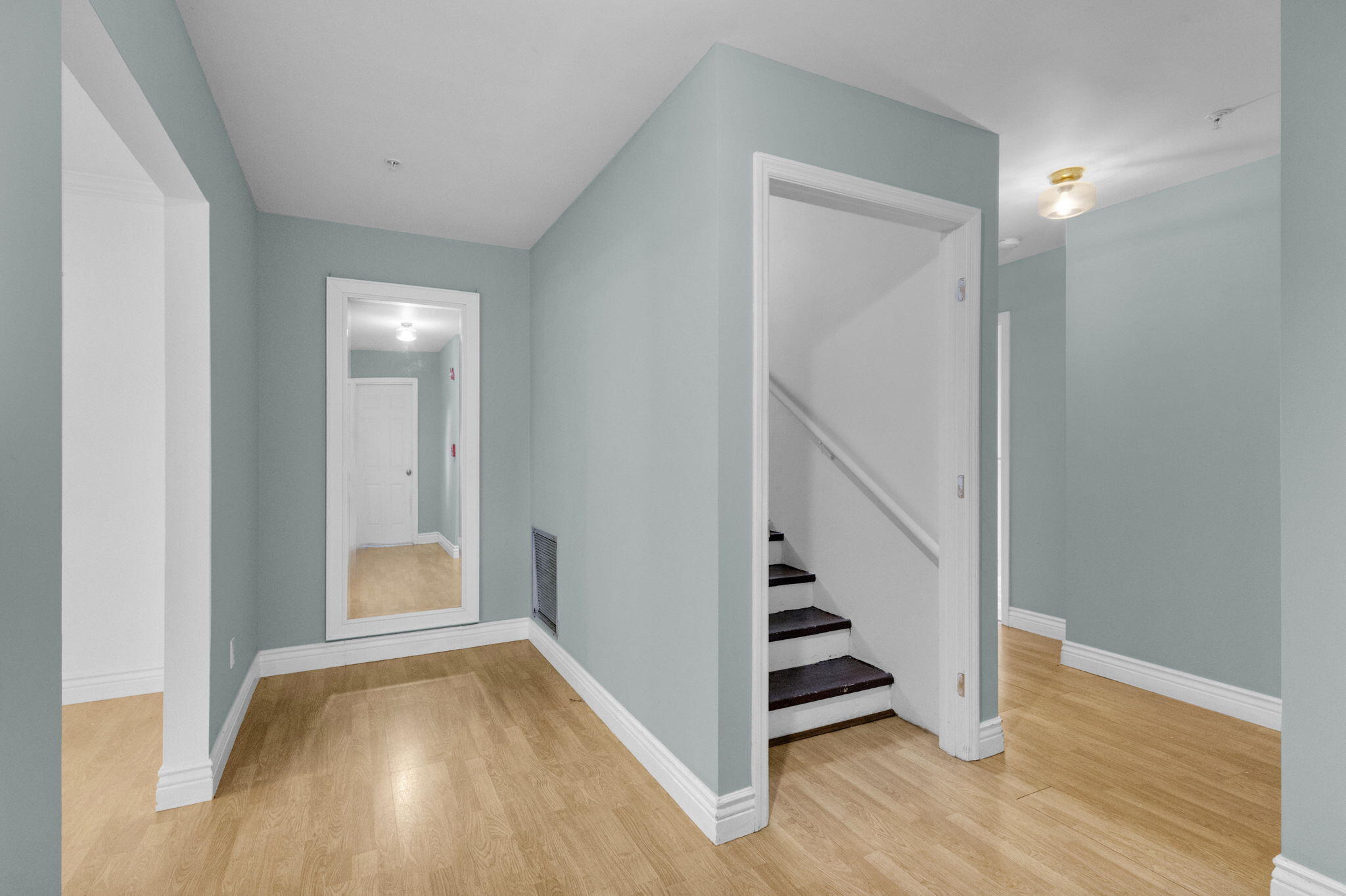 8888 Southeast Colony Street Hobe Sound, FL 33455 - Photo 18 of 69 a view of a hallway with wooden floor and entryway