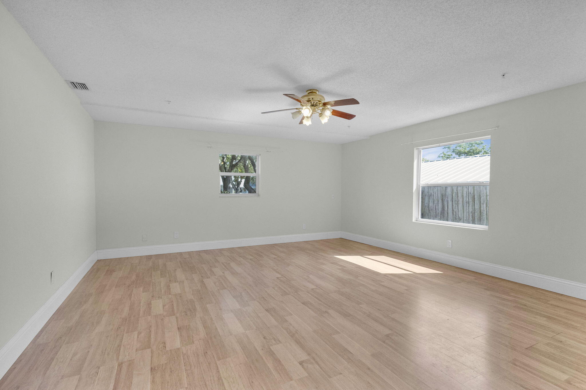 8888 Southeast Colony Street Hobe Sound, FL 33455 - Photo 20 of 69 wooden floor in an empty room with a window
