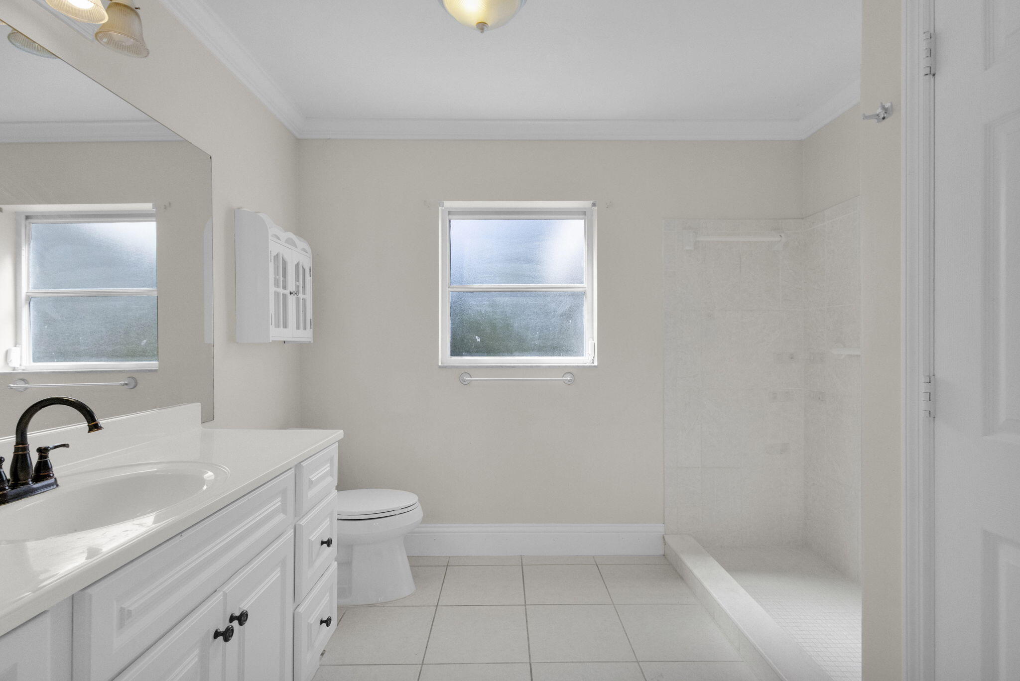 8888 Southeast Colony Street Hobe Sound, FL 33455 - Photo 22 of 69 a bathroom with a toilet sink and mirror