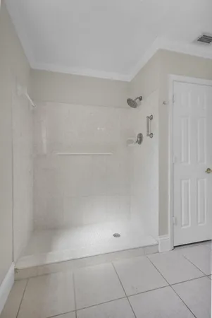 an empty room with wooden floor closet and ceiling fan