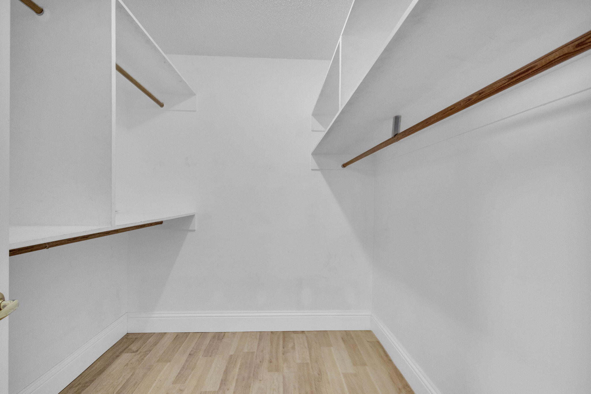 8888 Southeast Colony Street Hobe Sound, FL 33455 - Photo 26 of 69 a view of walk in closet with empty racks
